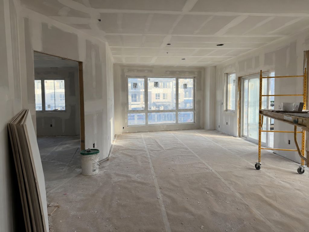 Apartment unit with smooth finished drywall walls and ceiling, ready for paint