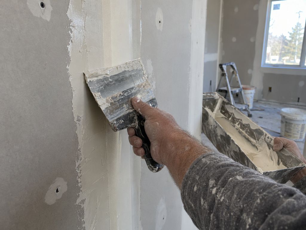 Taped drywall seam with smooth joint compound and a taping knife